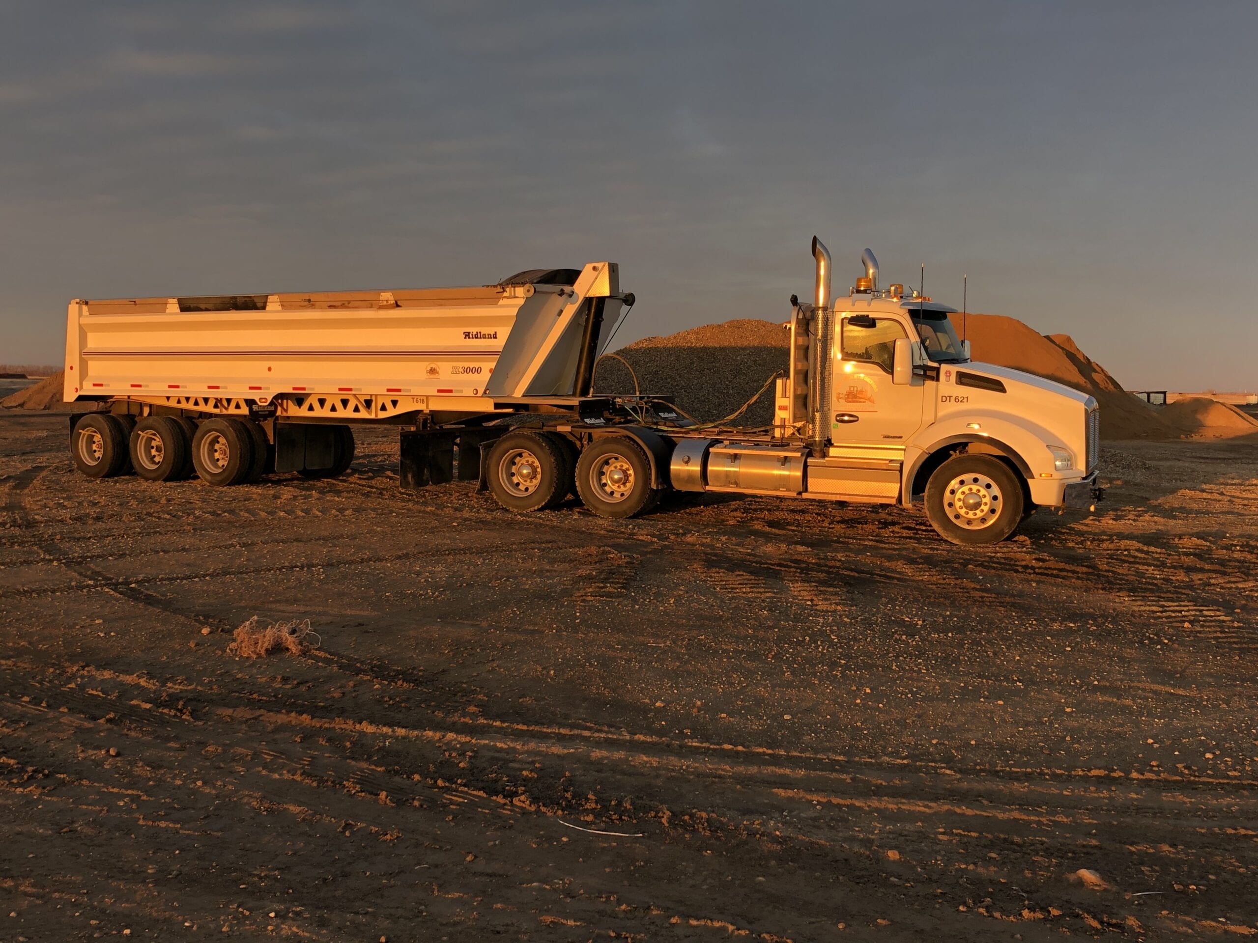 IMG_0954 Semi-truck at dusk pulling a load of gravel to the landfill.